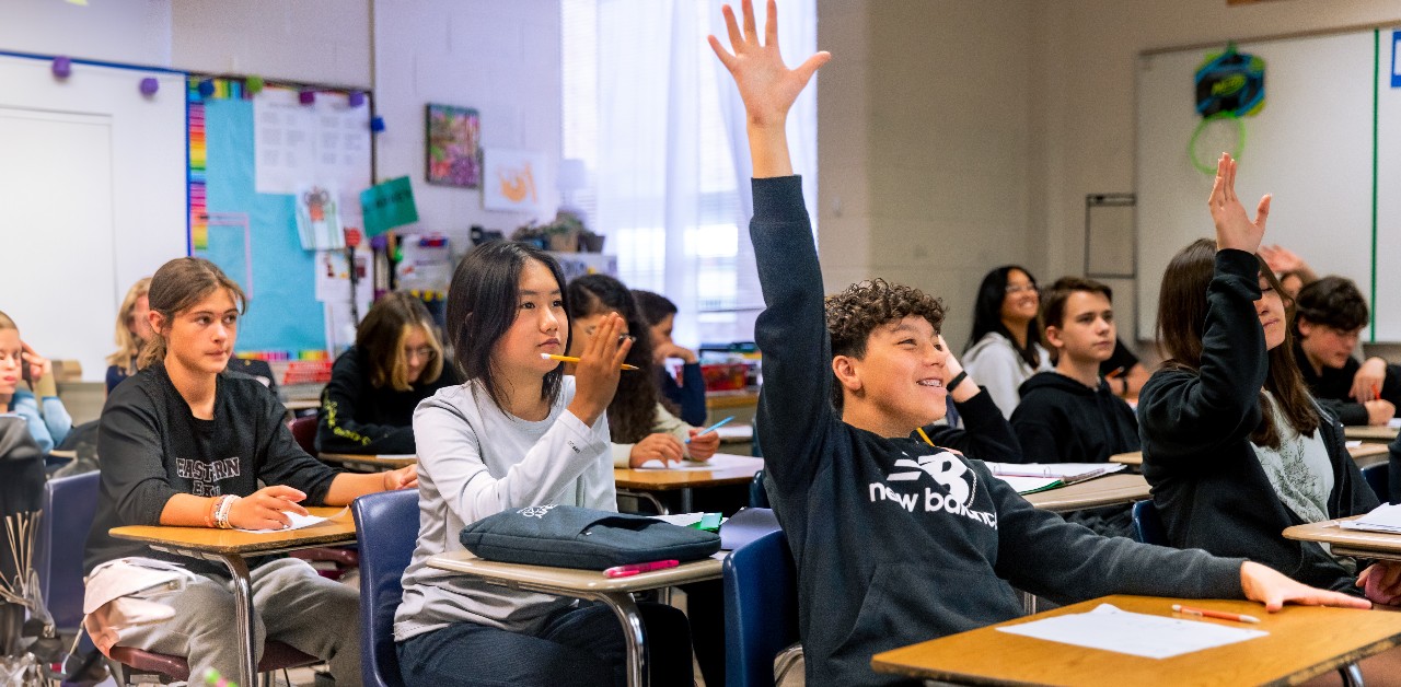 An EMS student raises his hand during class.